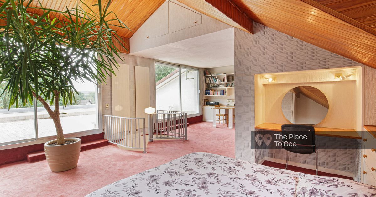 Typical eighties designer house with vintage furniture rug wallpaper