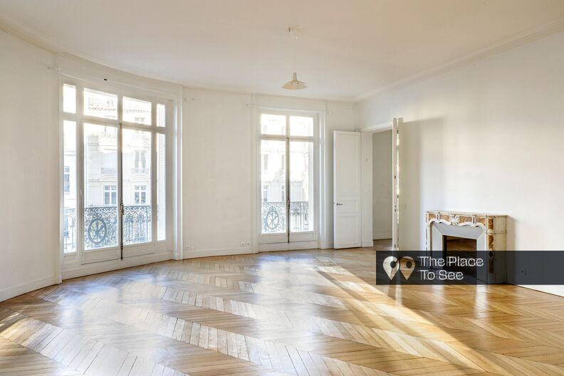 Appartement haussmannien vide aux murs blancs avec balcon