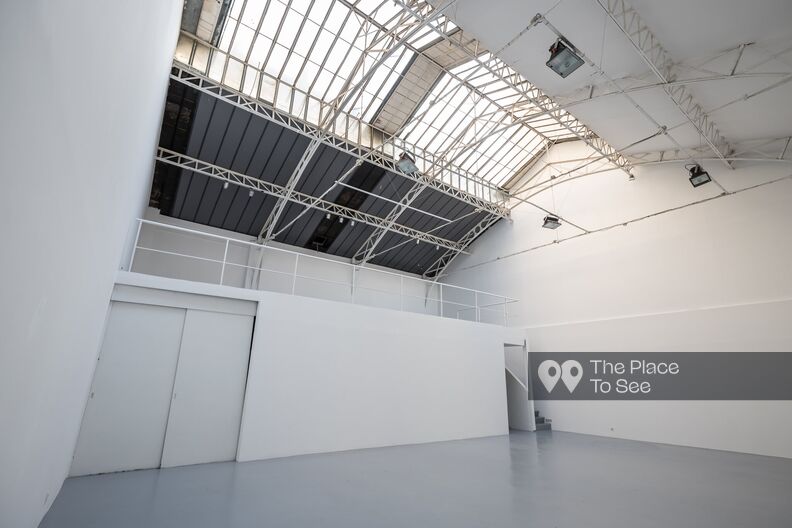 Gallery with high ceilings and glass roof