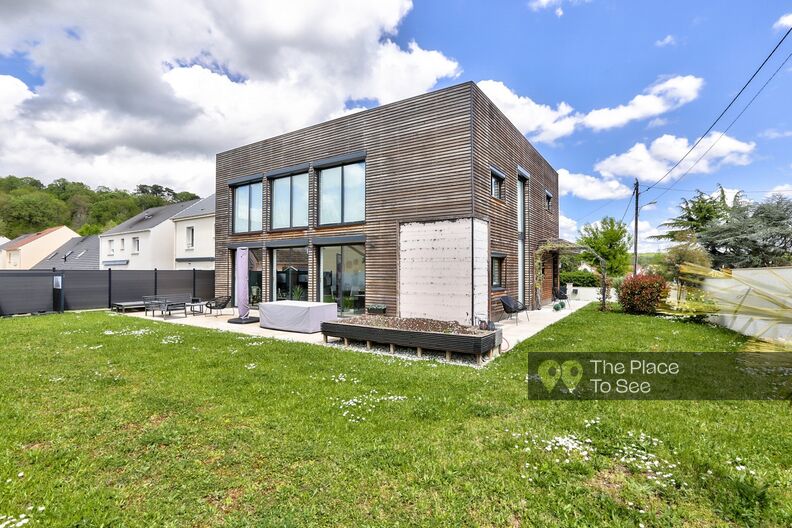 Cubic architect's house with wooden facade