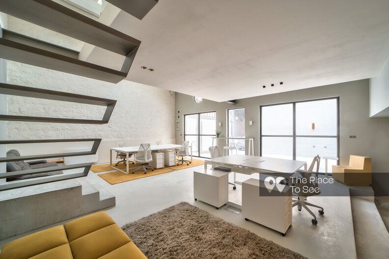 Raw and minimalist architect's loft with its glass-roofed courtyard