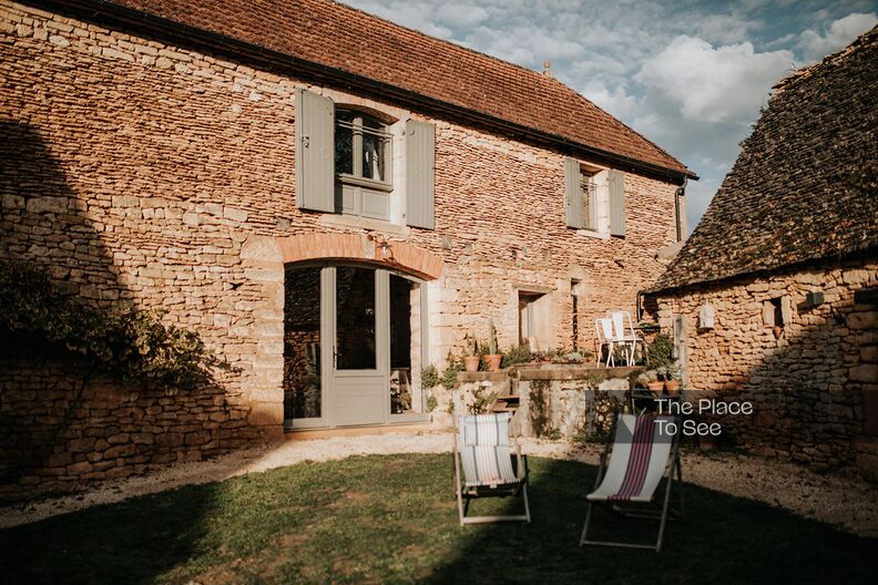 Magnificent renovated stone farmhouse with slate roofs in the forest