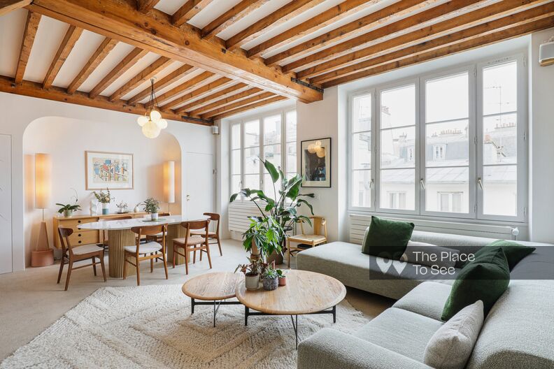 Elegant Parisian apartment with concrete floors and wooden beams