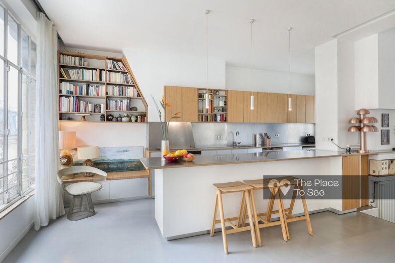 loft concrete floor with glass roof and designer furniture