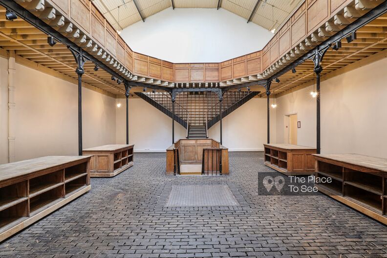 industrial reception area made of bricks and wood under a glass roof