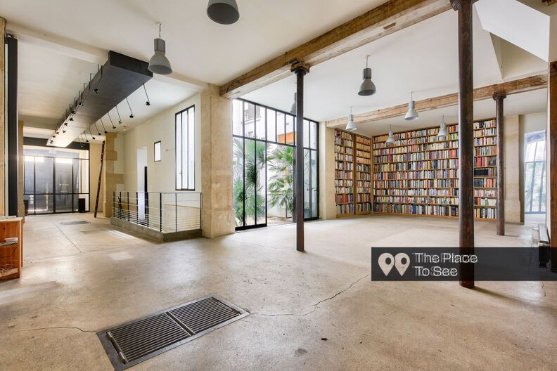 Industrial-style bookstore with concrete floor and metal beams