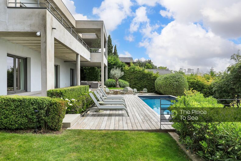 Architect-designed house with raw concrete structure and swimming pool