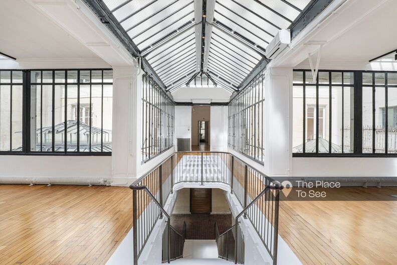 Old bright printing house with wooden floors and glass roof