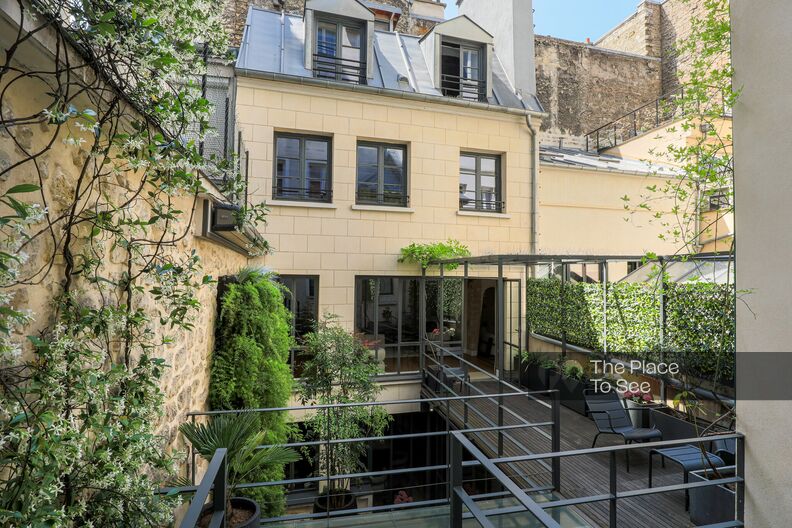Parisian house with stone walls with patio and walkway