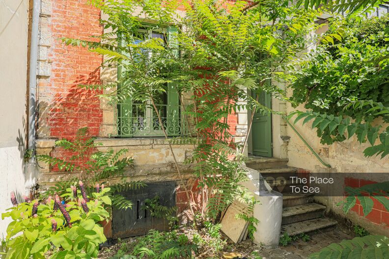 Faded detached house with garden, brick wall