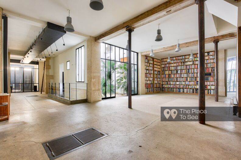 Industrial-style bookstore with concrete floor and metal beams