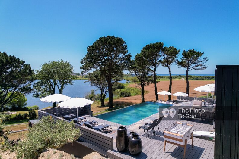 Contemporary house with a pool and a view of a lake