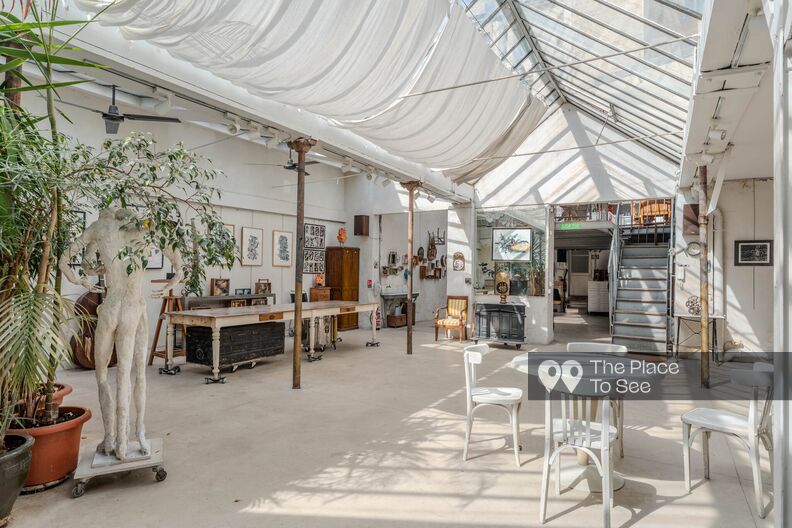 Weathered artist’s studio beneath a glass roof