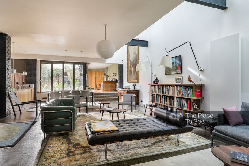 Loft-style house with elegant decor, concrete floors, wood panelling and glass walls