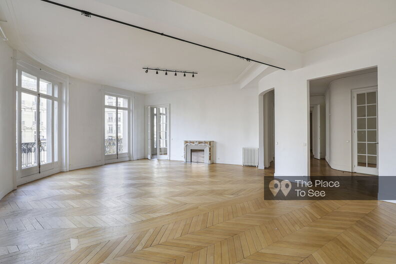 Empty Haussmannian apartment with white walls and a balcony